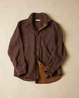 Brown shirt with a textured finish on a beige background