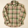 Green and pink plaid shirt on a beige background