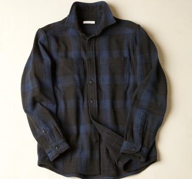 Blue black plaid shirt on a beige background