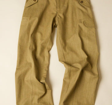 Pair of beige green pants on a light beige background