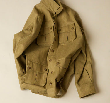 Khaki field jacket on a beige background