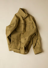 Khaki field jacket on a beige background