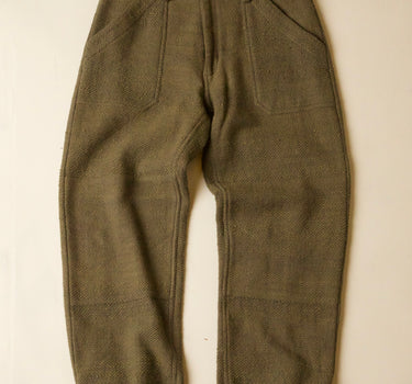 Pair of olive green pants on a beige background