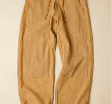 Tan pants with drawstring on a beige background