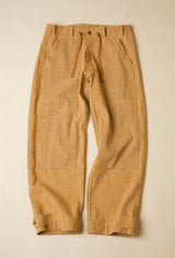 Tan pants with drawstring on a beige background
