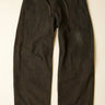Dark brown pants on a beige background