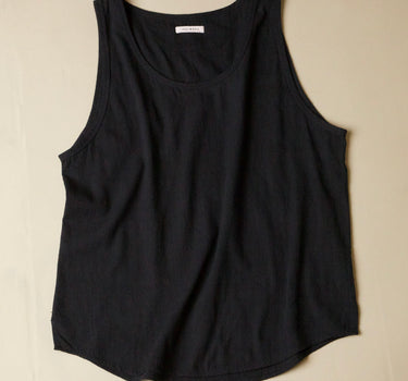Black tank top on a beige background