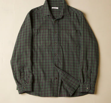 Green plaid shirt on a beige background
