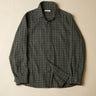 Green plaid shirt on a beige background