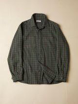 Green plaid shirt on a beige background