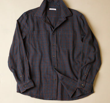 Dark plaid shirt on a beige background