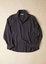 Dark plaid shirt on a beige background