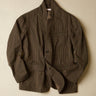 Black and brown jacket with a subtle  stripe pattern on a beige background