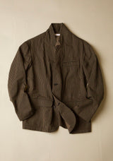 Black and brown jacket with a subtle  stripe pattern on a beige background