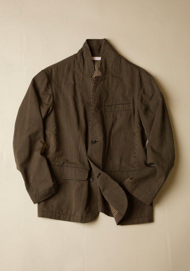 Black and brown jacket with a subtle  stripe pattern on a beige background