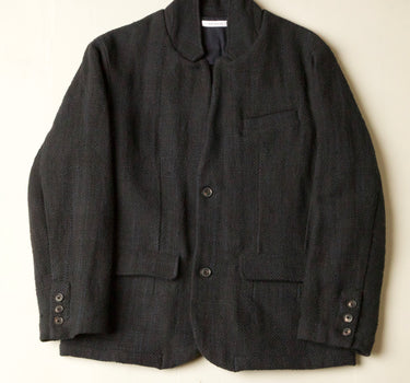 Dark gray jacket on a light beige background