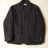 Dark gray jacket on a light beige background