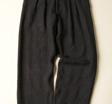 Black pants on a beige background