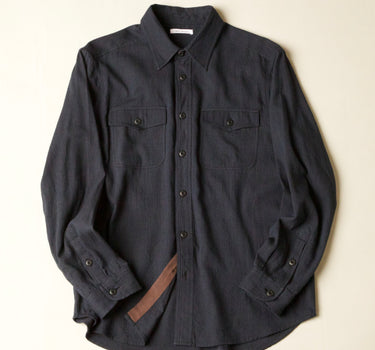 Dark gray blue shirt on a beige background