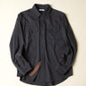 Dark gray blue shirt on a beige background