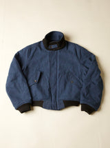 Blue jacket with black trim on a beige background