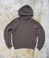 Brown hoodie on a textured gray surface