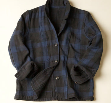 Dark Blue and Black plaid jacket on a beige background