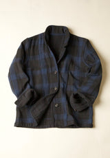 Dark Blue and Black plaid jacket on a beige background
