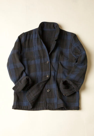 Dark Blue and Black plaid jacket on a beige background