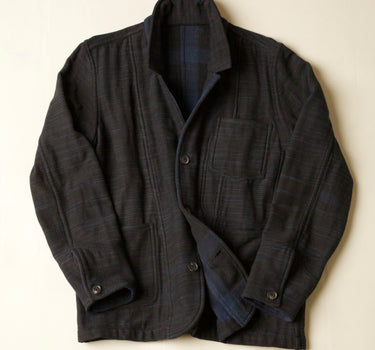 Dark blue jacket with a plaid pattern on a light beige background