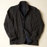 Dark blue jacket with a plaid pattern on a light beige background
