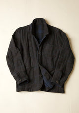 Dark blue jacket with a plaid pattern on a light beige background