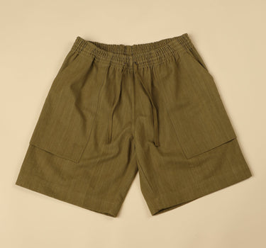 Green shorts on a beige background