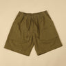 Green shorts on a beige background