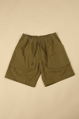 Green shorts on a beige background