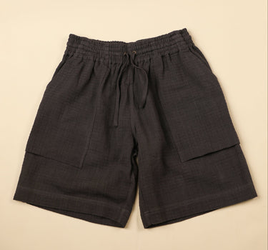 Dark gray shorts on a beige background