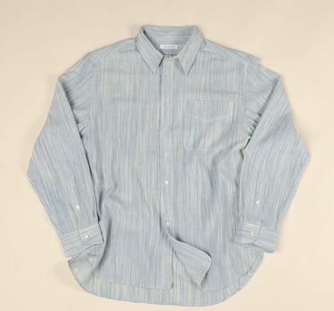 Light blue and natural long sleeve shirt on beige background