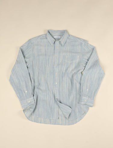 Light blue and natural long sleeve shirt on beige background