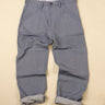 Ligh blue gray pants on a beige background