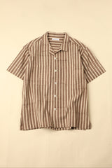 Flat brown and white striped shirt on a beige background