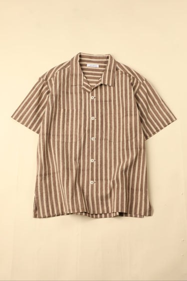 Flat brown and white striped shirt on a beige background