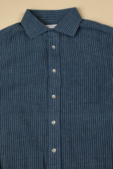 Blue striped shirt with collar and buttons on a beige background