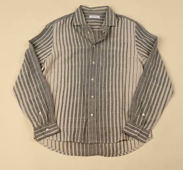 Grey and natural striped shirt on a beige background