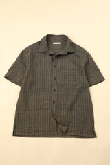 Flat green checkered shirt on a beige background