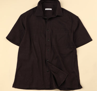 Plum shirt on a beige background