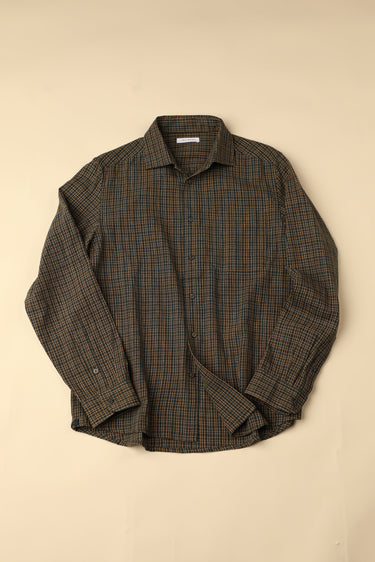Flat long sleeved green and brown checkered shirt on a beige background
