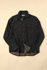 Flat black and blue striped shirt on a beige background