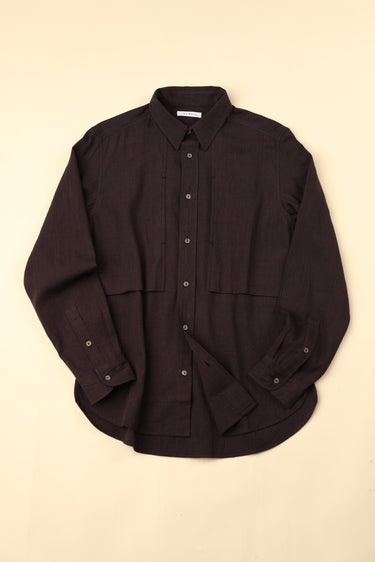 Flat dark plum shirt on a beige background