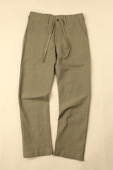 Green pants on a beige background