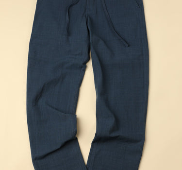 warm medium blue pants on a beige background